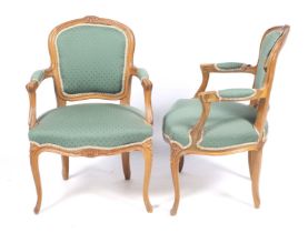 A pair of French stained beech armchairs with fluted and carved details.