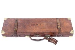 A leather bound wooden Holland & Holland fitted gun case with several accessories.