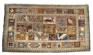 A Persian style wool rug with various animals depicted.