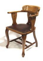 A Liberty style Art Nouveau blonde oak armchair.