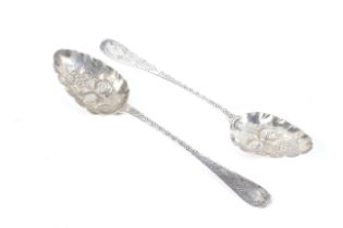 A pair of George III silver table spoons later embossed as berry spoons.