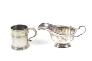 A silver christening mug and a sauce boat.