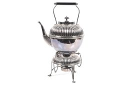 An early 20th century silver-plated round part fluted tea kettle on a stand with a lamp.