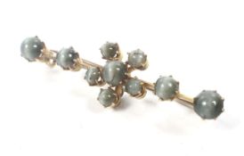 A late Victorian gold and green cats eye chrysoberyl cluster bar brooch.