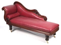 A William IV mahogany show-wood chaise longue with carved scroll and acanthus decoration.