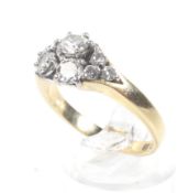 A vintage Continental diamond nine stone abstract cluster ring. The round brilliants approx. 1.