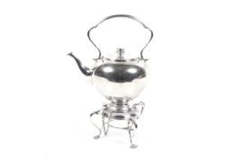 A silver-plated round tea kettle on stand.