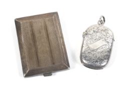 An Edwardian silver vesta/match case and a later silver match book cover.