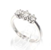 A vintage 18ct white gold and diamond three stone ring. The graduated round brilliants approx. 0.