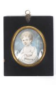 A late 19th century miniature, an oval portrait on ivory of a young child.