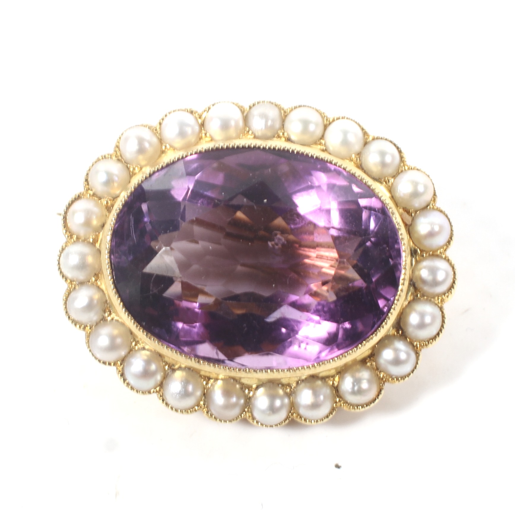 A late Victorian gold, amethyst and half-pearl oval brooch.