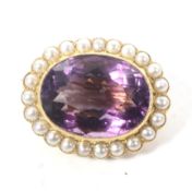 A late Victorian gold, amethyst and half-pearl oval brooch.