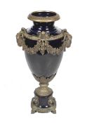 A large contemporary brass and blue glazed ceramic urn.