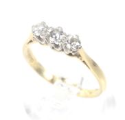 A vintage 18ct gold and diamond three stone ring. The graduated round brilliants approx. 0.