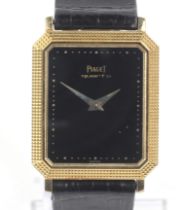 Piaget, a mid-size Swiss gold rectangular wrist watch.