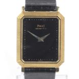 Piaget, a mid-size Swiss gold rectangular wrist watch.