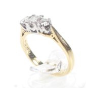 A modern 18ct gold and diamond three stone ring.