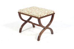 A 20 th century mahogany reeded X frame upholstered stool.