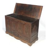 An 18th century and later carved oak coffer mule chest with three drawers.