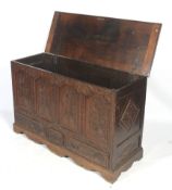 An 18th century and later carved oak coffer mule chest with three drawers.