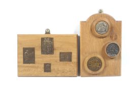 Two oak plaques with seven squared and circular medallions.