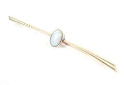 An early 20th century rose gold and opal single stone bar brooch.