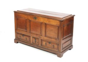 An 18th century oak panelled mule chest.