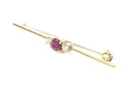 A vintage 18ct gold, ruby and diamond three stone bar brooch.