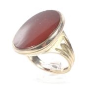 A vintage 9ct gold and carnelian oval signet ring. The plain oval carnelian approx.