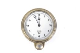 Automobilia - A Smiths L brass cased dashboard clock with silvered dial and winder under.