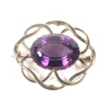 A vintage 9ct gold and oval amethyst brooch. Centred with an oval mixed-cut amethyst, approx. 18.