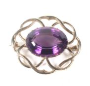 A vintage 9ct gold and oval amethyst brooch. Centred with an oval mixed-cut amethyst, approx. 18.
