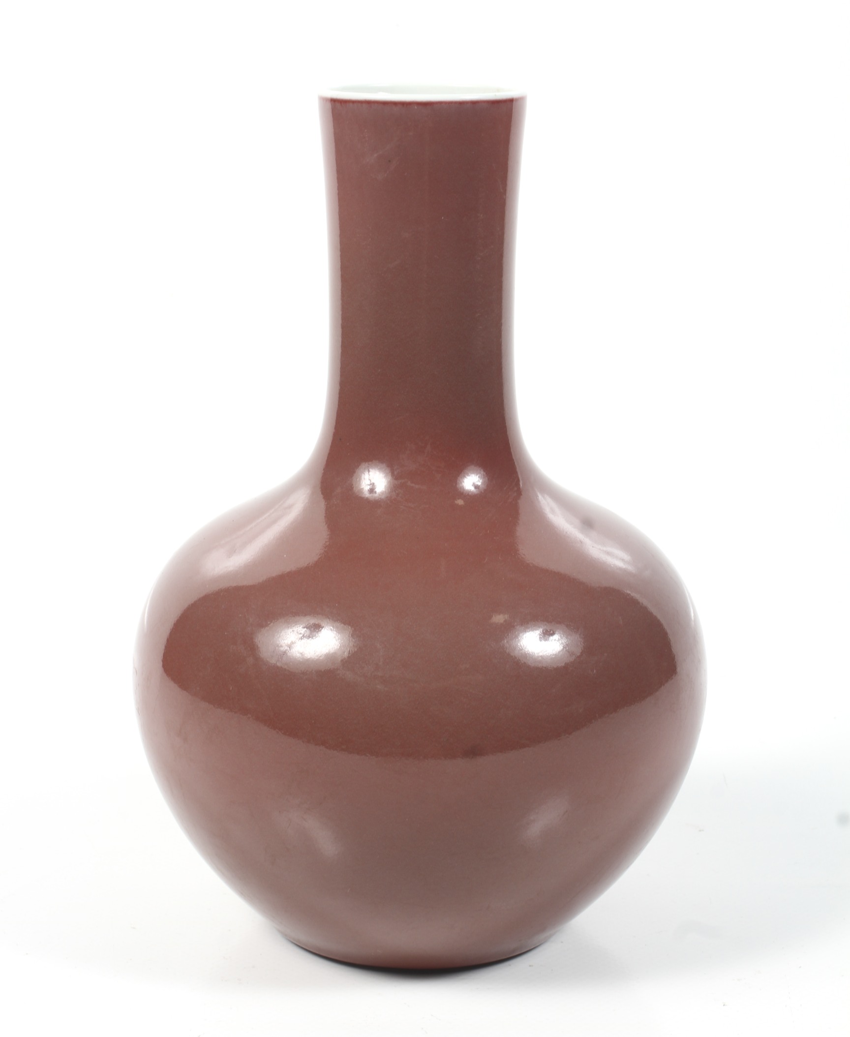 A Chinese copper-red tianquiping form bottle vase. Six character Qianlong mark to base. H24cm.