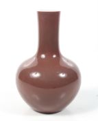 A Chinese copper-red tianquiping form bottle vase. Six character Qianlong mark to base. H24cm.