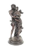 A 1970s patinated bronze sculpture of a romantic couple on a stepped base. Unsigned, H33.