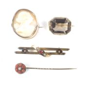 Thee Victorian and later gold brooches and a stick pin.