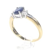 A modern 18ct gold, sapphire and diamond three stone ring.