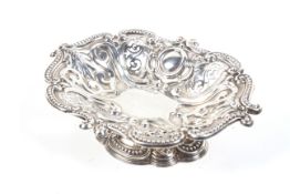 A silver shaped-oval pierced and embossed pedestal sweet dish.