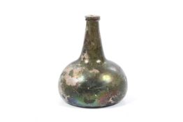 A 17th/18th century green glass wine bottle.