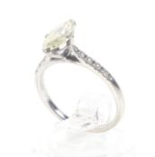 A modern marquise diamond solitaire ring with small diamond shoulders.