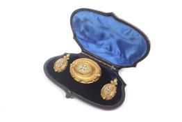 A pair of mid Victorian gold and half-pearl oval pendent earrings and a matching brooch.