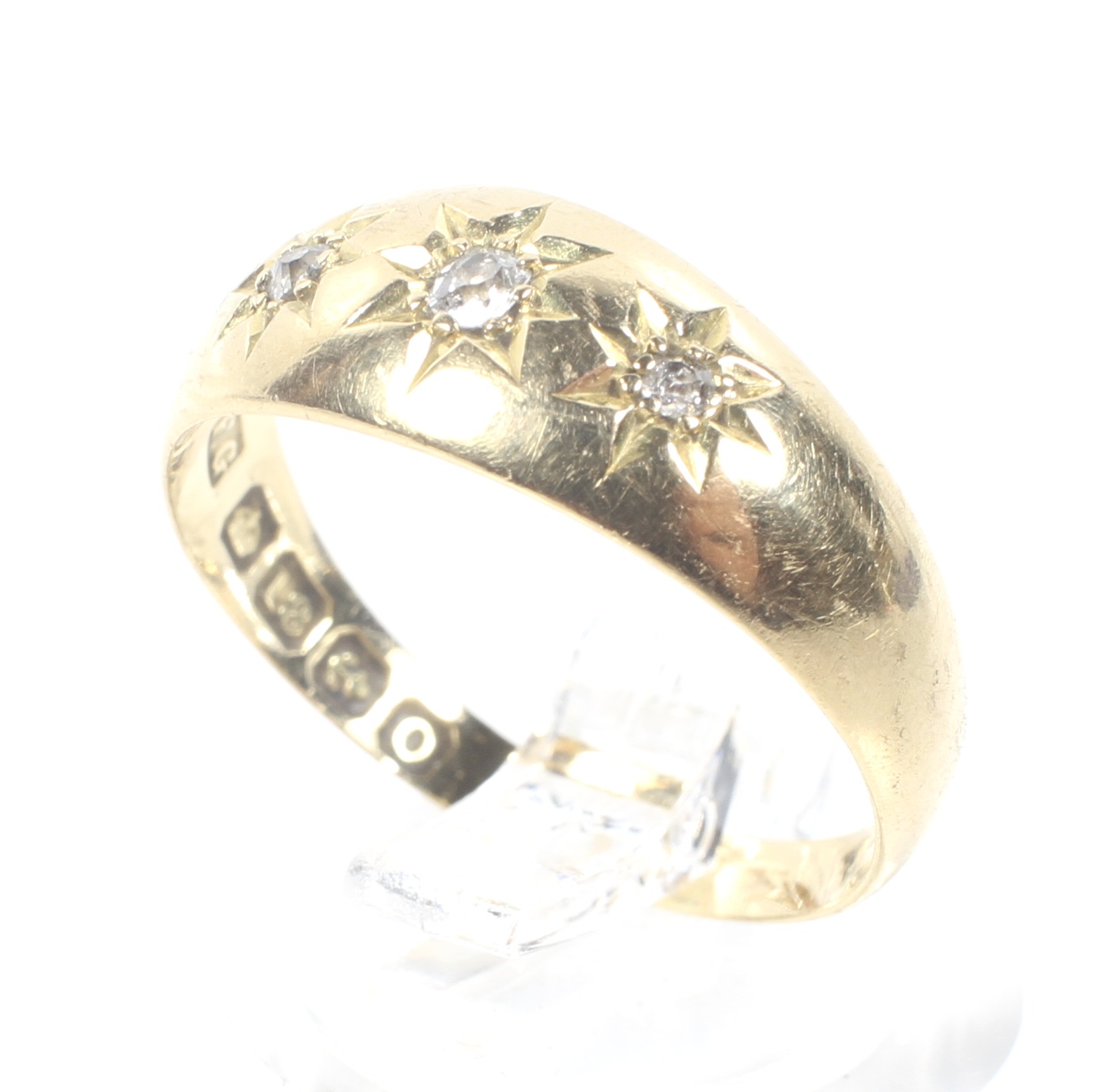 An early 20th century 18ct gold and diamond three stone gypsy ring,