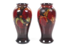 Two William Moorcroft signed flambe vases.