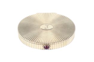 Cartier, a 9ct gold oval 'star-burst' fluted compact, circa 1946.