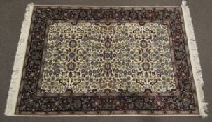 A Hereke Yun hand made carpet of wool on cotton comprising of a navy blue centre ground with