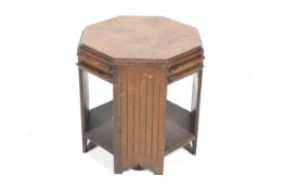 An Art Deco oak octagonal two tier occasional table.