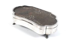 An early 20th century silver and tortoiseshell mounted kidney-shaped jewellery box.