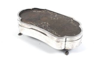 An early 20th century silver and tortoiseshell mounted kidney-shaped jewellery box.