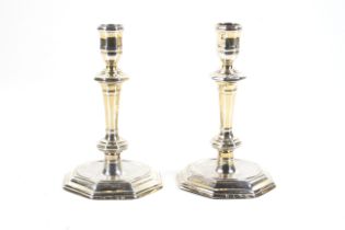 A pair of Queen Anne cast silver octagonal candlesticks.