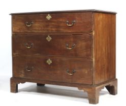 A Georgian mahogany chest, on bracket feet, of unusual form with three graduated drawers.